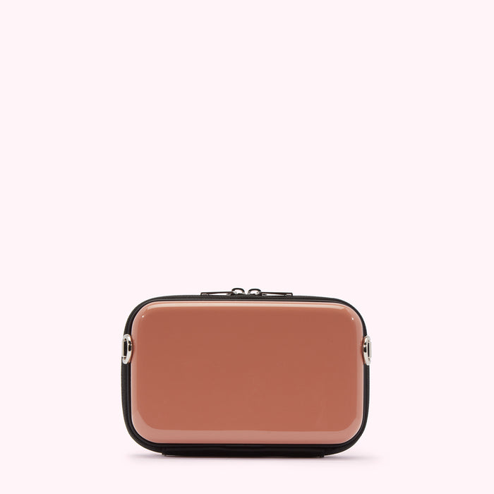 A dusty rose rectangular crossbody bag with black trim and silver hardware against a white background.