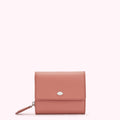 Dusty rose leather wallet with a silver lip emblem.