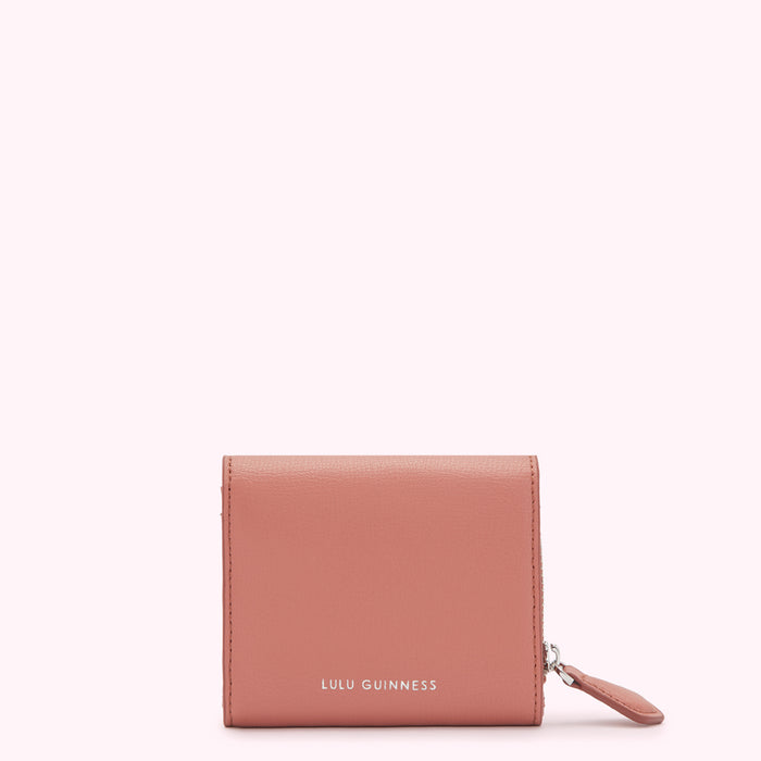 Dusty rose Lulu Guinness zip-around wallet against a white background.