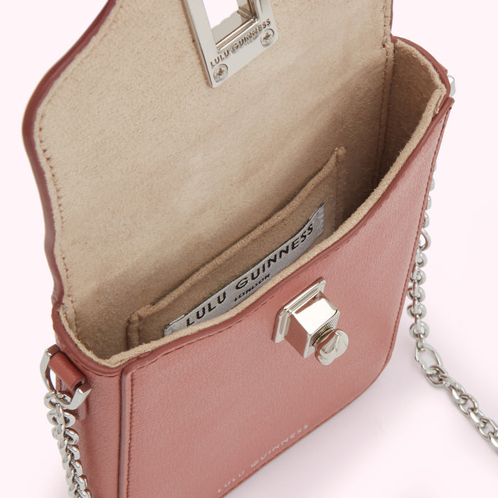 Dusty rose Lulu Guinness mini crossbody bag open to reveal beige interior and silver chain strap.