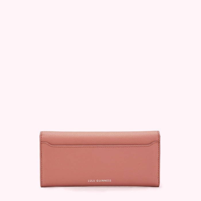 Dusty rose Lulu Guinness wallet on a white background.