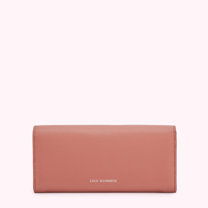 A dusty rose Lulu Guinness wallet on a white background.