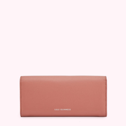 A dusty rose Lulu Guinness wallet on a white background.
