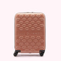 A mauve Lulu Guinness suitcase covered in a repeating pattern of embossed lips.