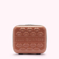 A dusty rose Lulu Guinness makeup case with embossed lips and the brand name.