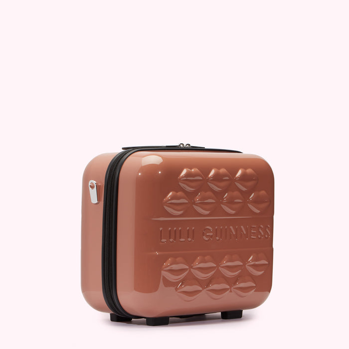A mauve Lulu Guinness makeup case with a lip design.