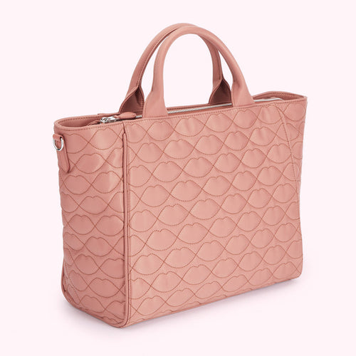 Dusty rose quilted handbag with lip print.