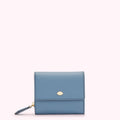A small, light blue leather wallet with a gold lip-shaped logo.