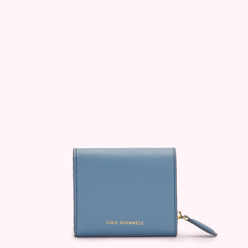 A small, powder blue, Lulu Guinness zip-around wallet on a white background.