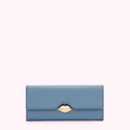 Dusty blue leather wallet with gold lip-shaped clasp against a white background.