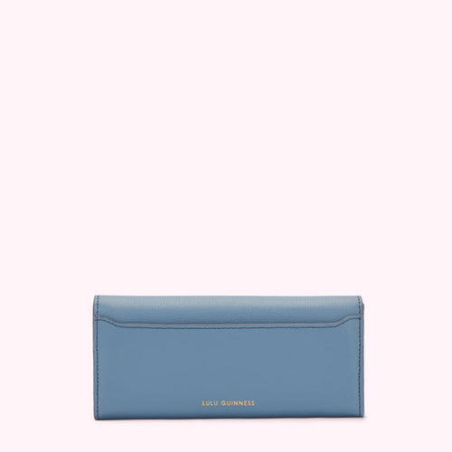 A powder blue leather wallet by Lulu Guinness, shown from the back.