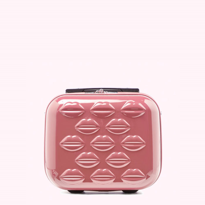 Pink rolling suitcase decorated with lip print.