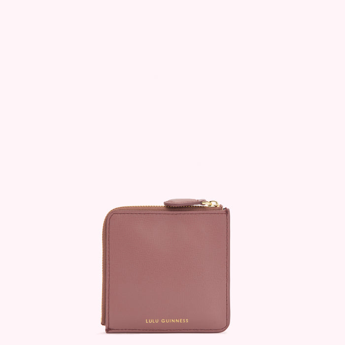 A dusty rose Lulu Guinness zip-around wallet against a white background.