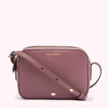 Dusty rose Lulu Guinness crossbody bag with gold zipper and hardware.