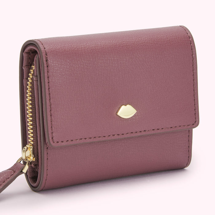 A purple leather wallet with a gold zipper and a gold lip-shaped logo. The background is white.
