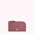 Dusty rose leather zip-around cardholder with gold zipper and logo.
