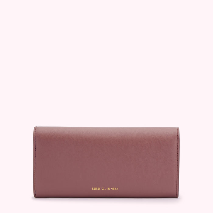 A mauve Lulu Guinness wallet against a white background.