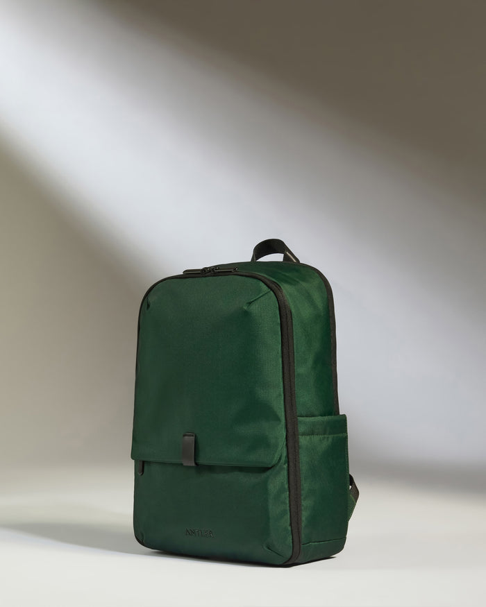 a green backpack with a black strap