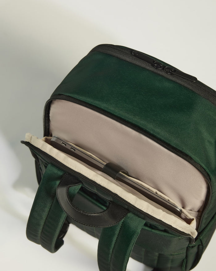 a green bag with a cell phone inside