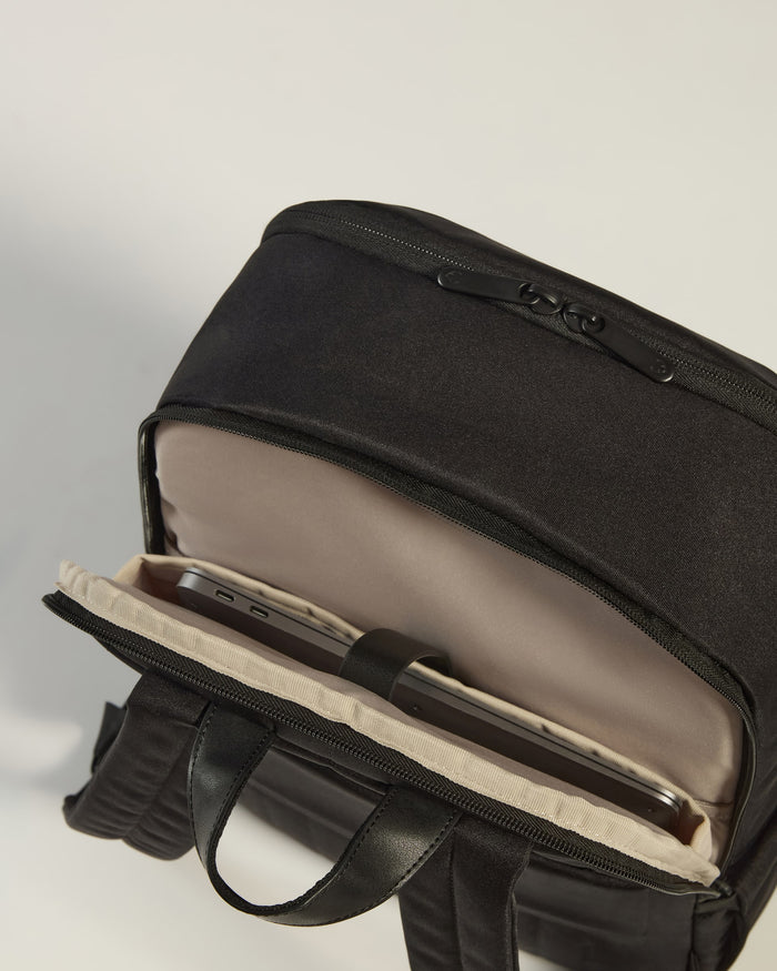 a black backpack with a cell phone inside