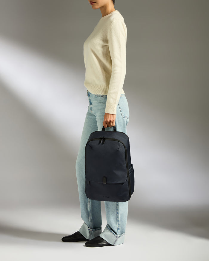 a woman holding a backpack