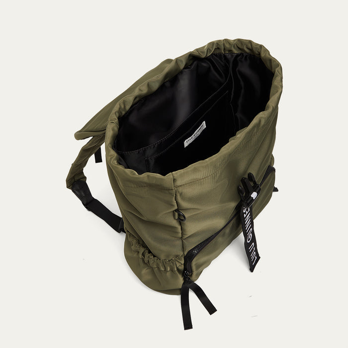 Green backpack with black interior on a white background
