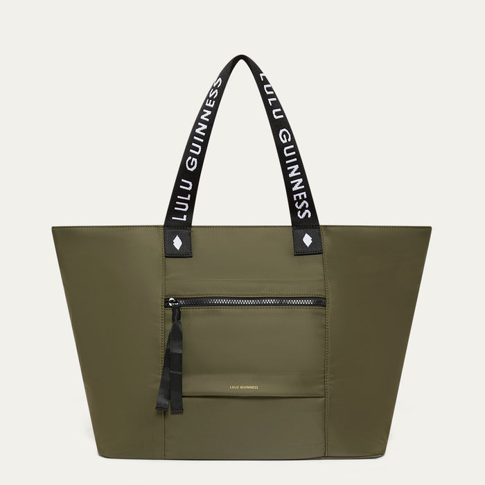 Green tote bag with black handles featuring 'Lulu Guinness' on a white background
