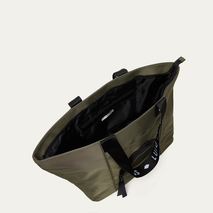 Green bag with black interior on a light grey background