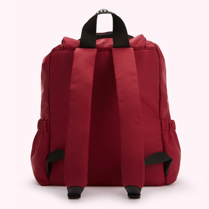 Red backpack with black straps.