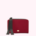 Red card holder with black ribbon and gold lip detail against a white background.