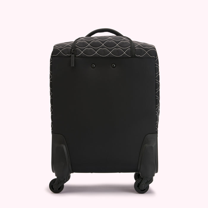 Black quilted carry-on suitcase with white stitching on a white background.