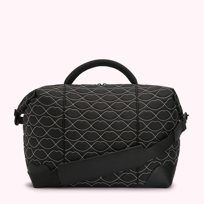 Black quilted duffel bag with white lip print.