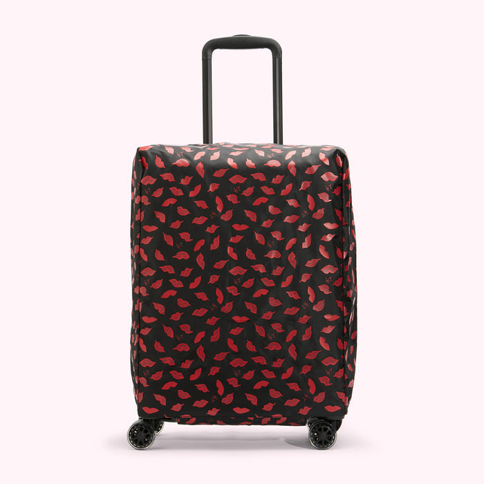 Black suitcase with red lips pattern.