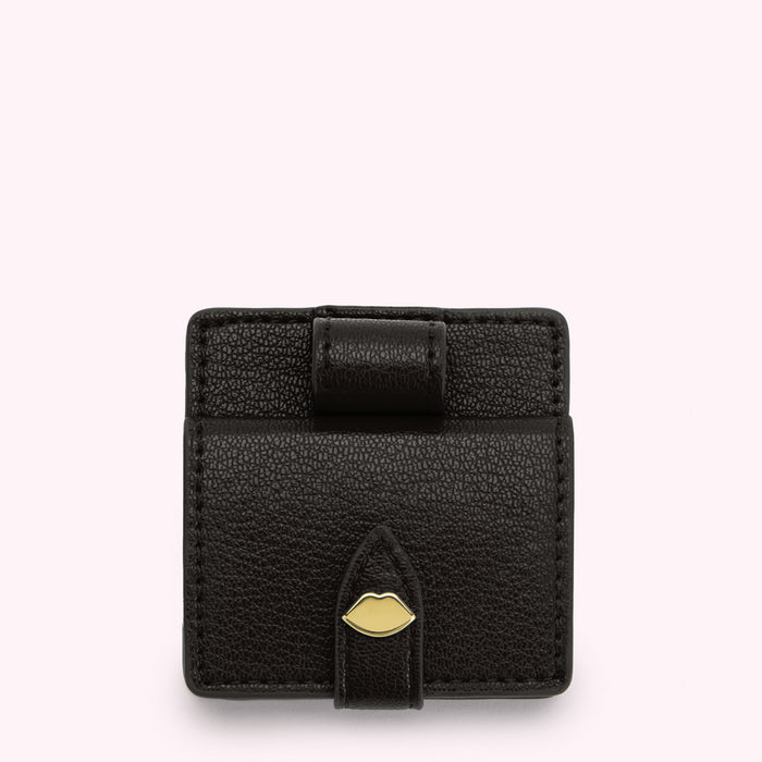Black leatherette lip-shaped compact mirror with gold clasp.