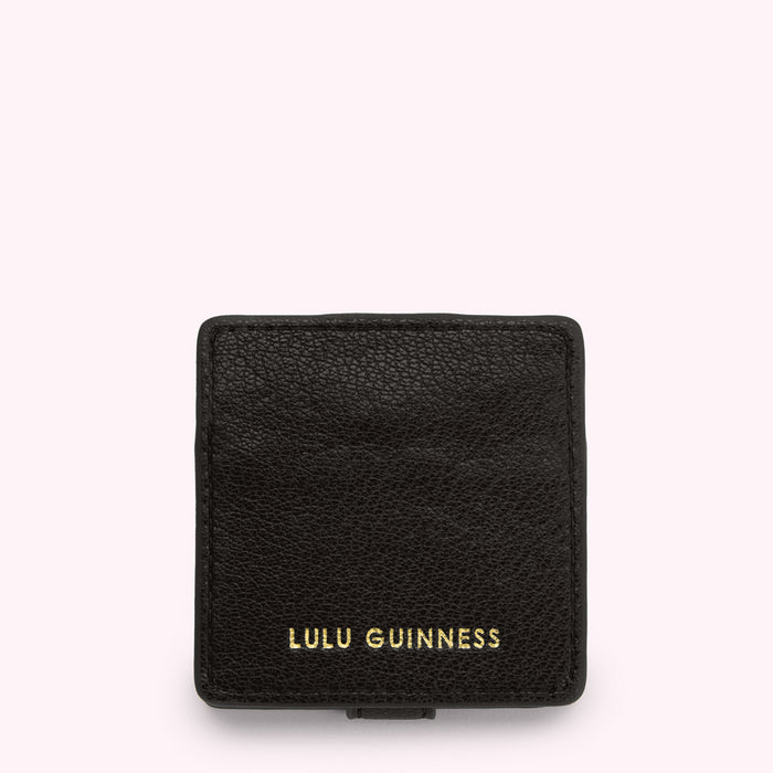 Black Lulu Guinness compact mirror against a white background.