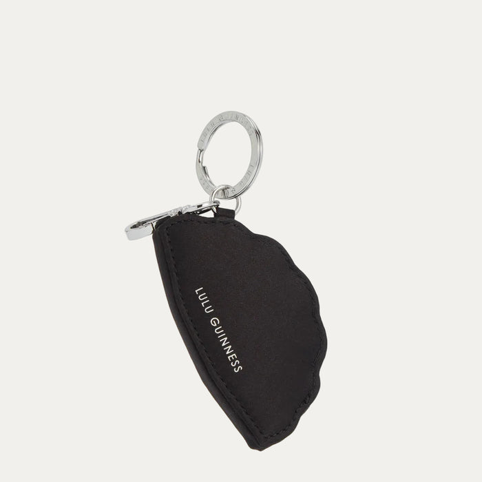 Black Lulu Guinness keyring in the shape of a seashell with silver ring.