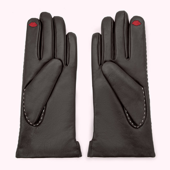 Pair of black leather gloves with a small red lip embroidered on each glove.