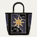 Handbag with sun and moon design on a white background