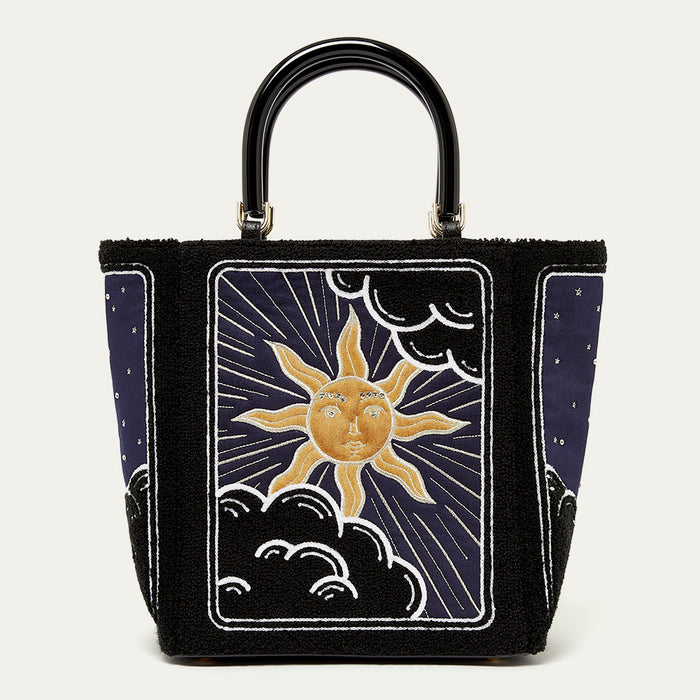 Handbag with sun and moon design on a white background