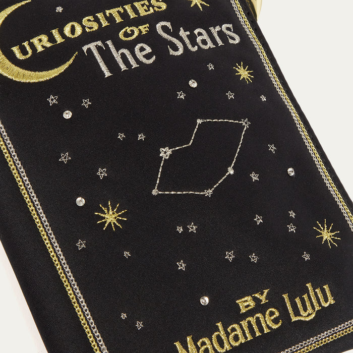 Embroidered book cover satin pouch with celestial design and 'Curiosities of the Stars' text.