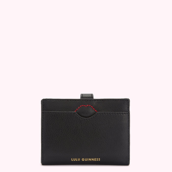 Black Lulu Guinness cardholder with red stitching detail.