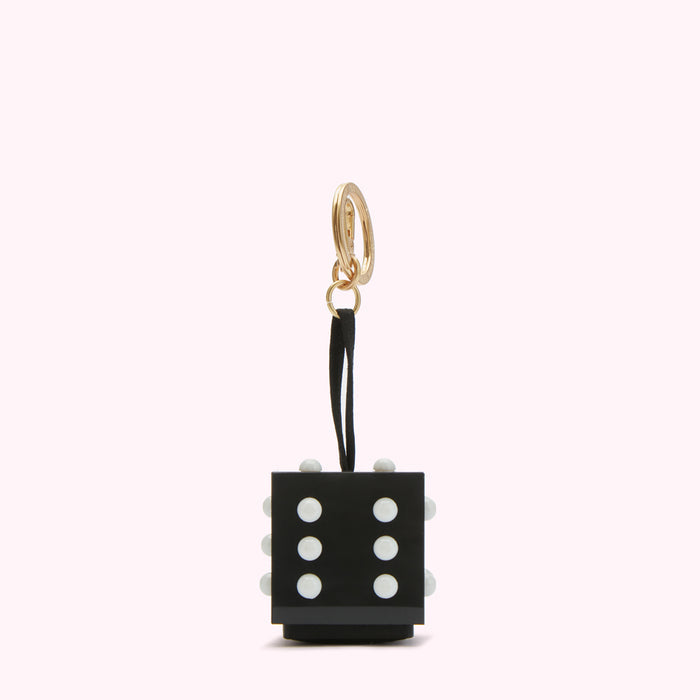Black and white dice-shaped keychain with gold ring.