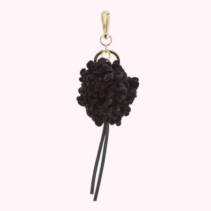 Black velvet pom-pom keychain with gold-coloured hardware and black leather tassel.