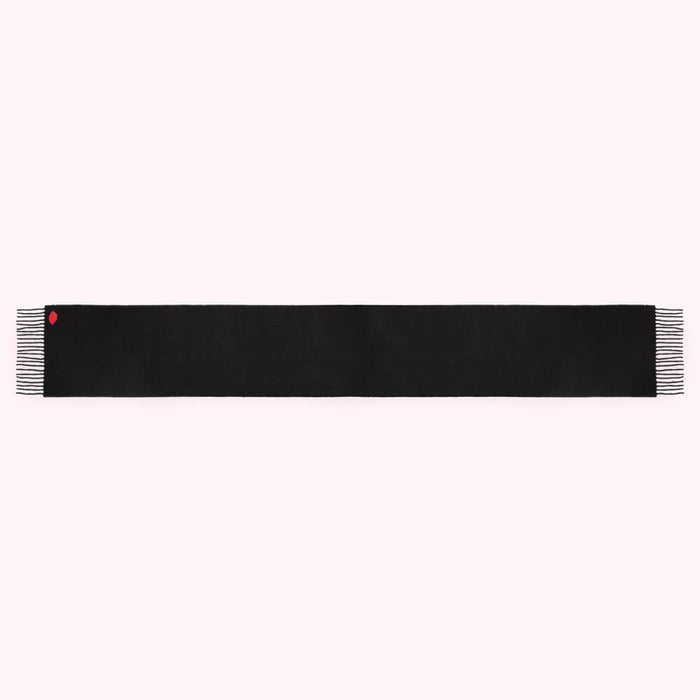 Black rectangular scarf with small red detail.