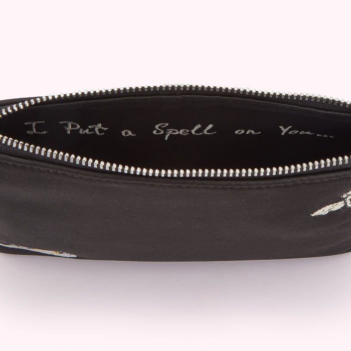 Black zip pouch with embroidered bees and the text "I Put a Spell on You" inside.