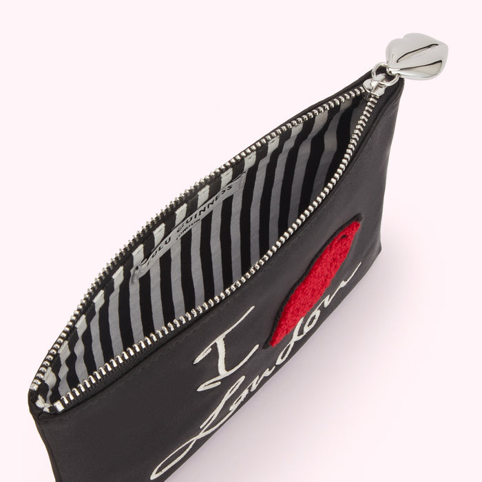 Black satin zip pouch with "I love London" embroidered on the front and a red felt heart; the lining is black and white striped.