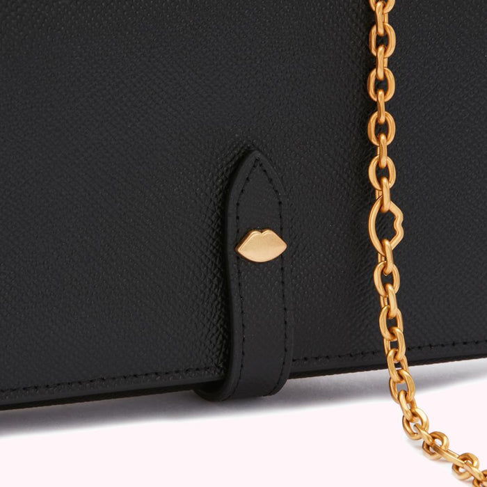 Close-up of a black leather wallet with a gold chain and lip-shaped detail.