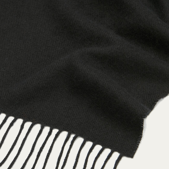 Close-up of a black fringed scarf.