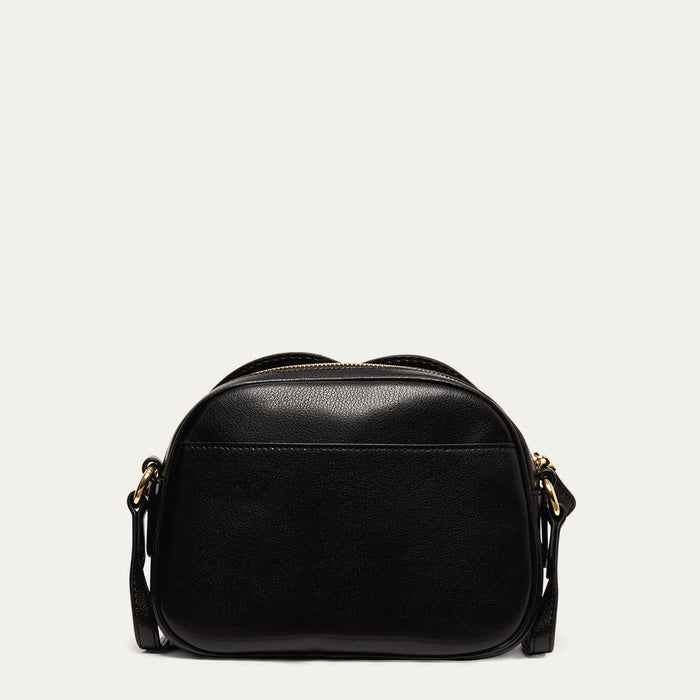 Back image of a black leather crossbody bag on a light grey background revealing the back pocket