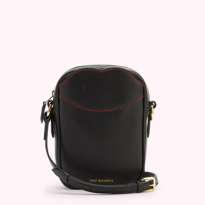 A front image of a black leather crossbody bag with gold hardware, contrasting red lip shaped stitching on the front pocket and a gold foil print 'Lulu Guinness' logo.